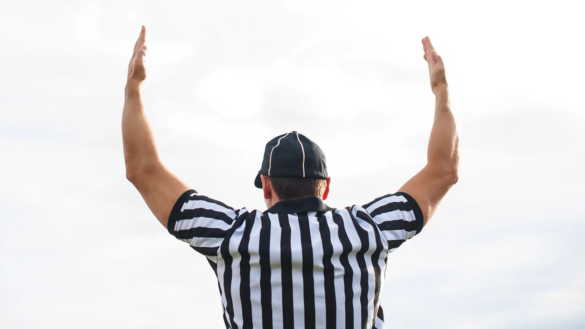 Football referee showing touchdown signal