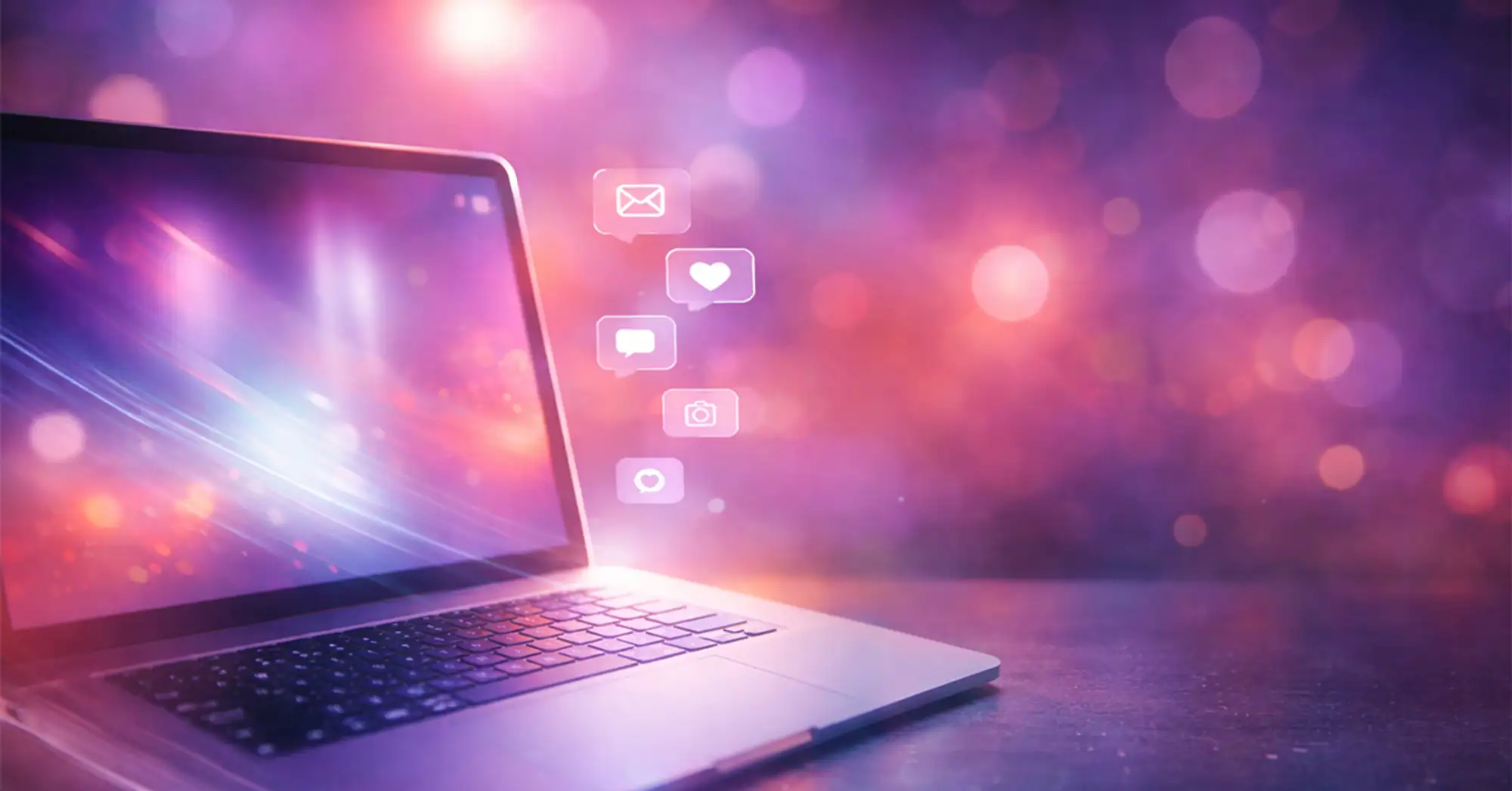 a colorful illustration of a laptop on a table with abstract lights and social media icons in the background