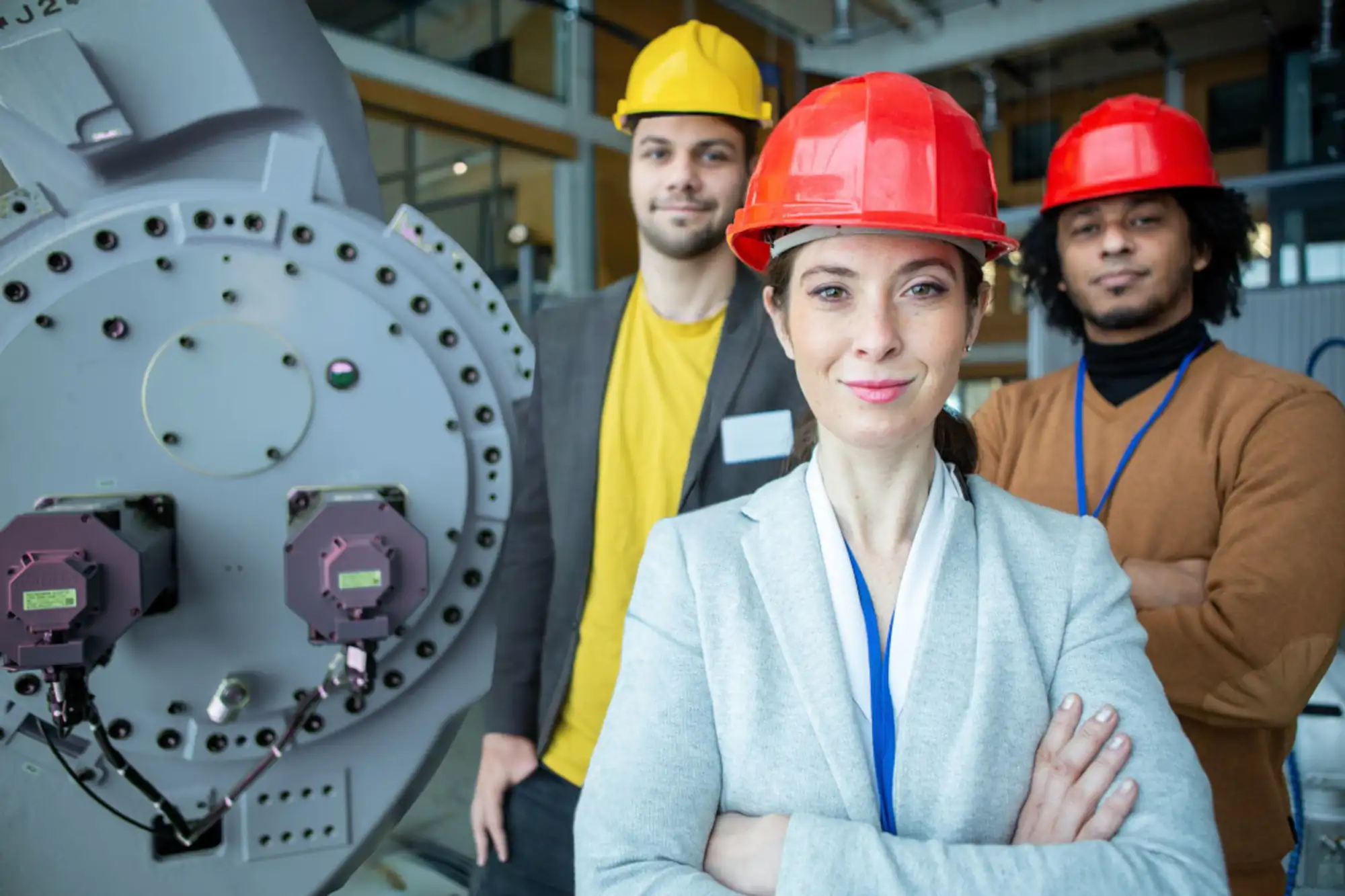 A confident team of coworkers standing on a factory floor